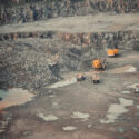 Yellow cars in a large quarry mining granite